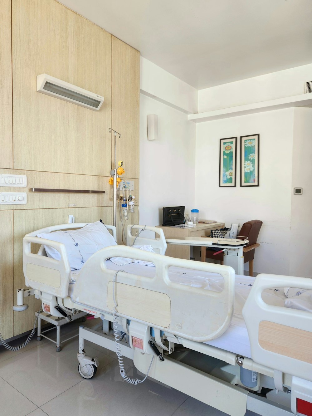 a hospital room with two beds and a desk