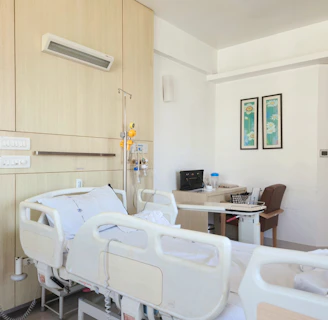 a hospital room with a bed and a desk