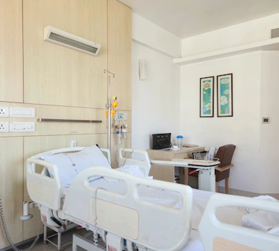 a hospital room with a bed and a desk