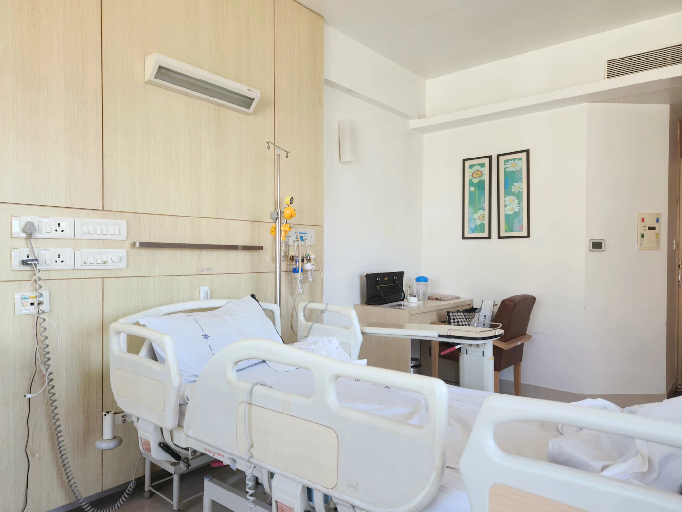 A hospital room with a bed and a desk, representing an injured crew member recovering ashore