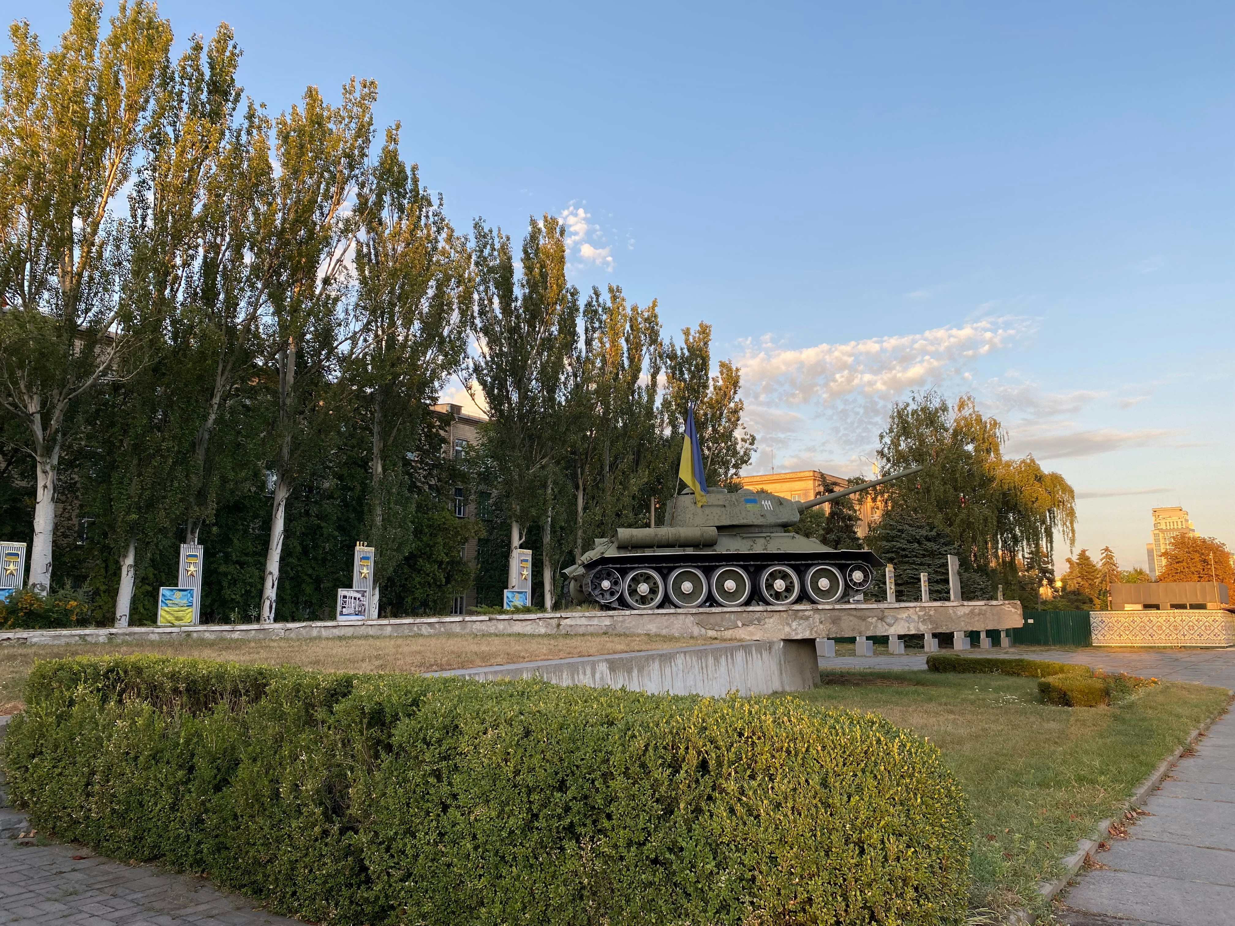 a tank sitting on top of a cement bridge