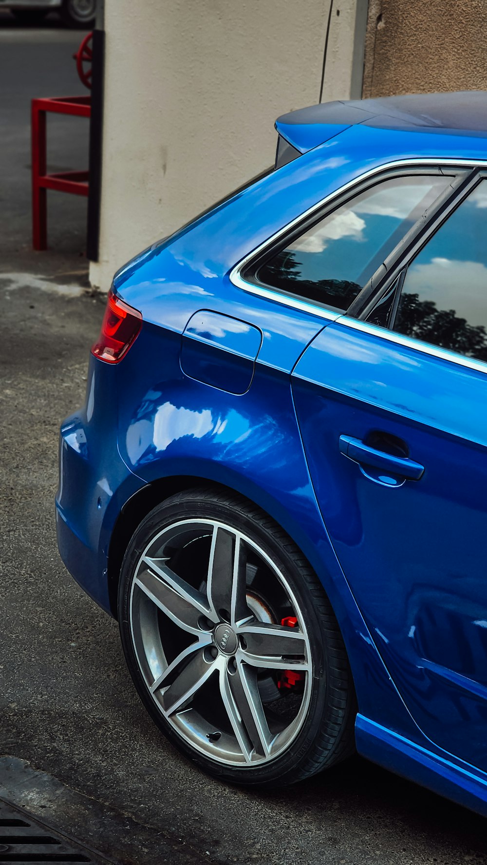 a blue car parked on the side of the road