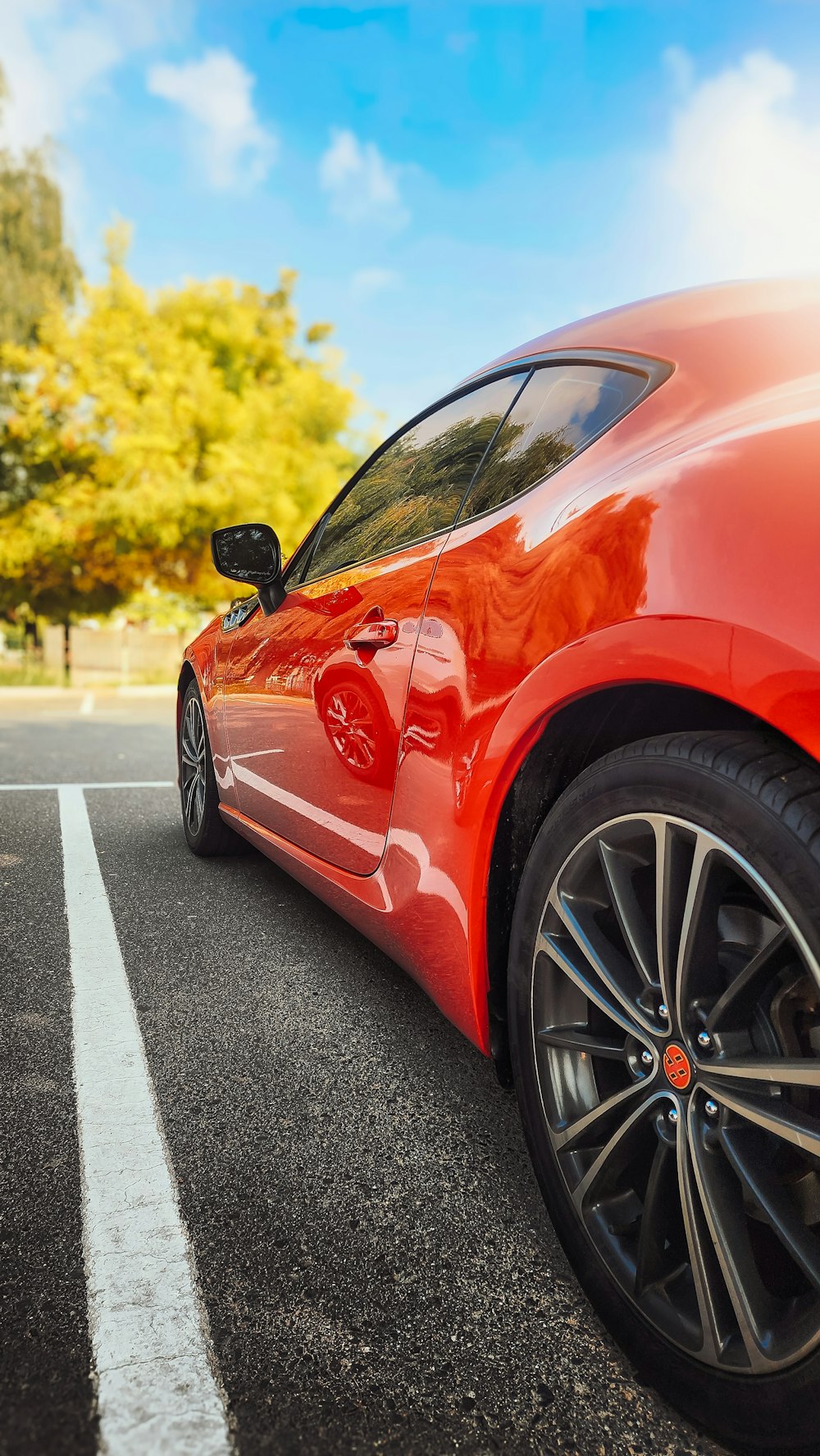 a red sports car parked on the side of the road