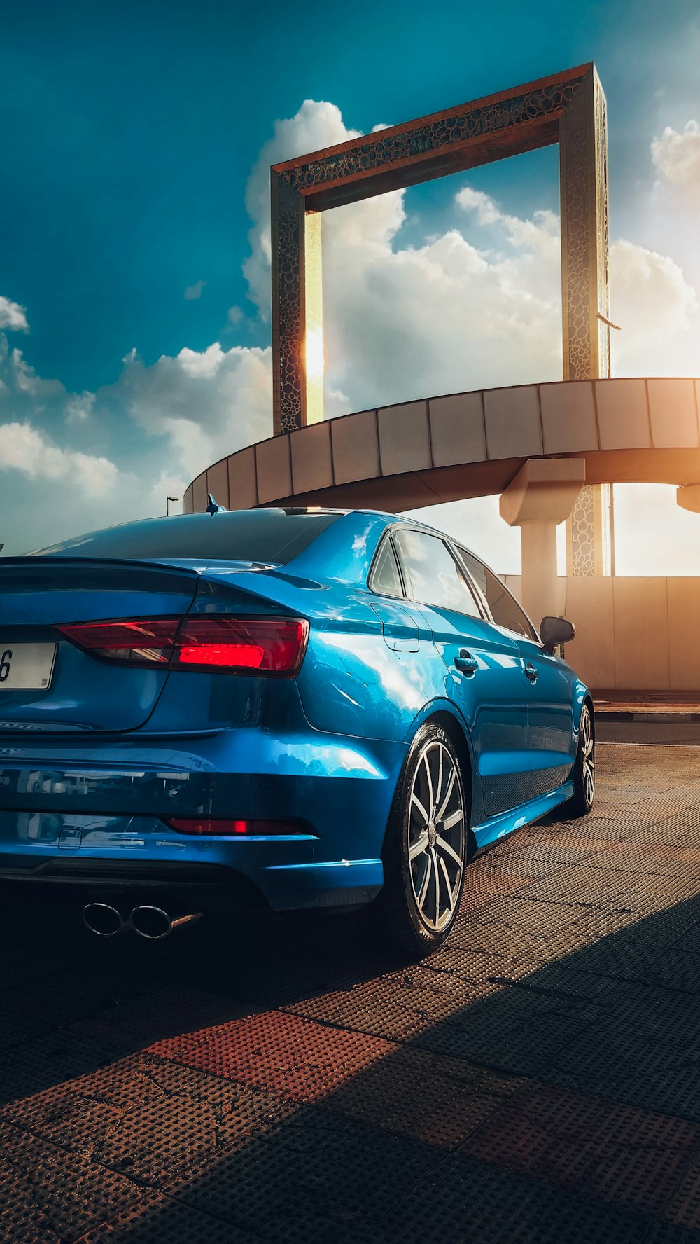 a blue car parked in front of a building