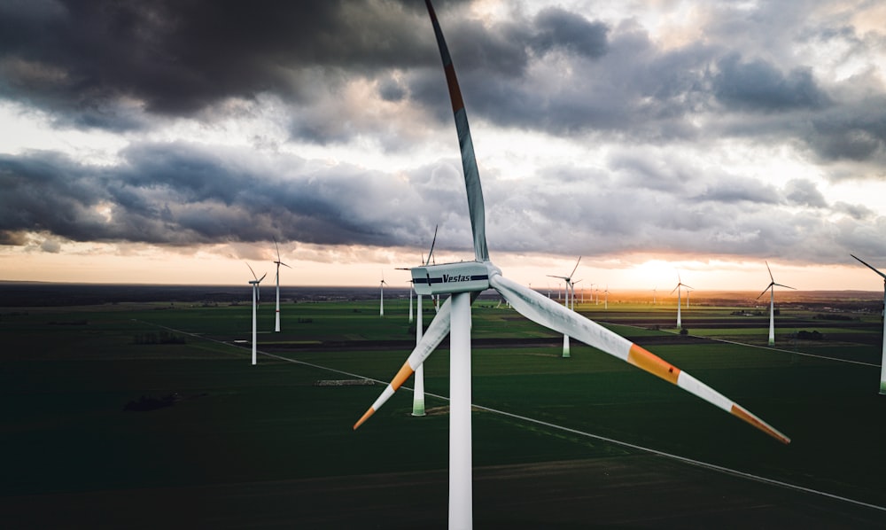 a wind farm with wind turbines in the background