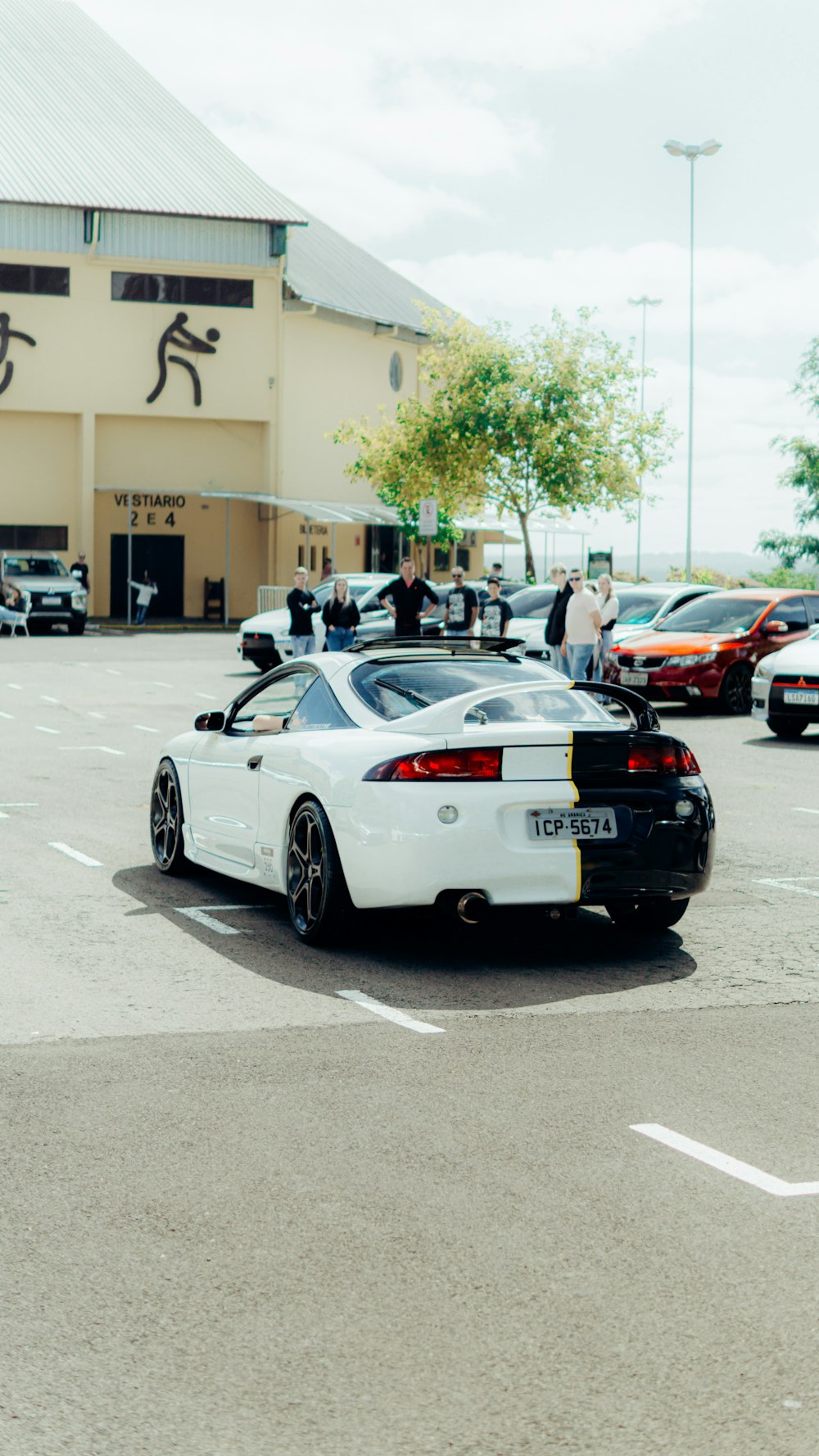 a white sports car parked in a parking lot