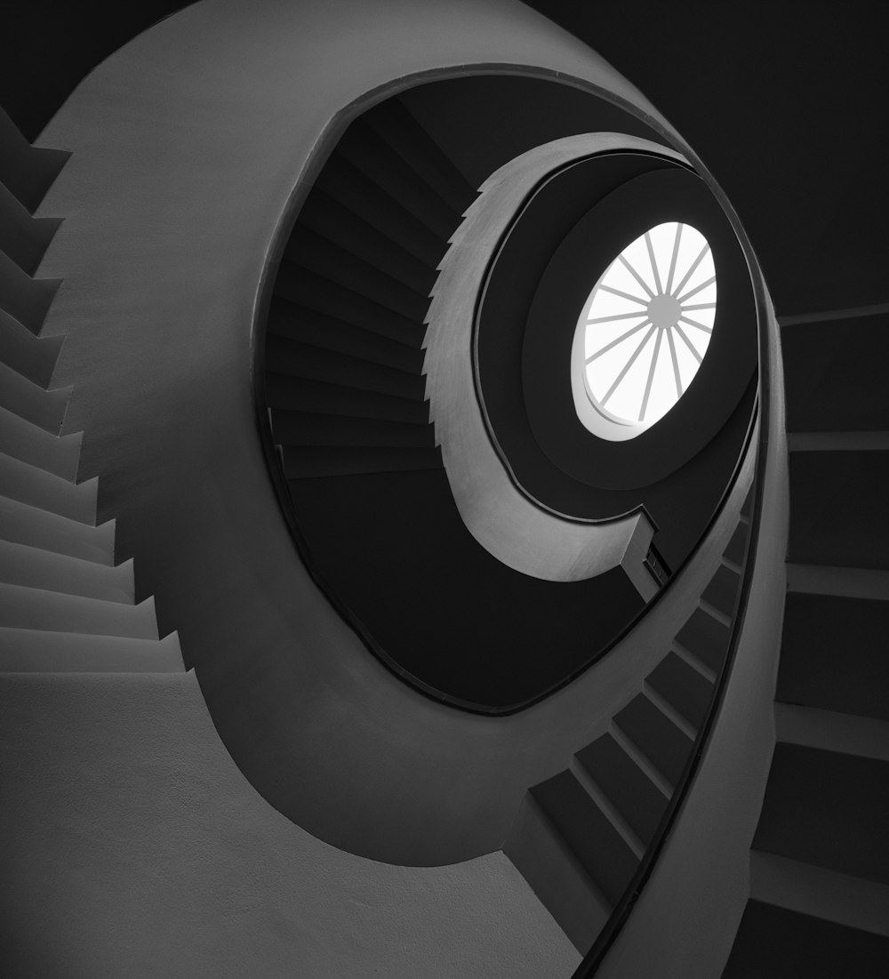 a black and white photo of a spiral staircase