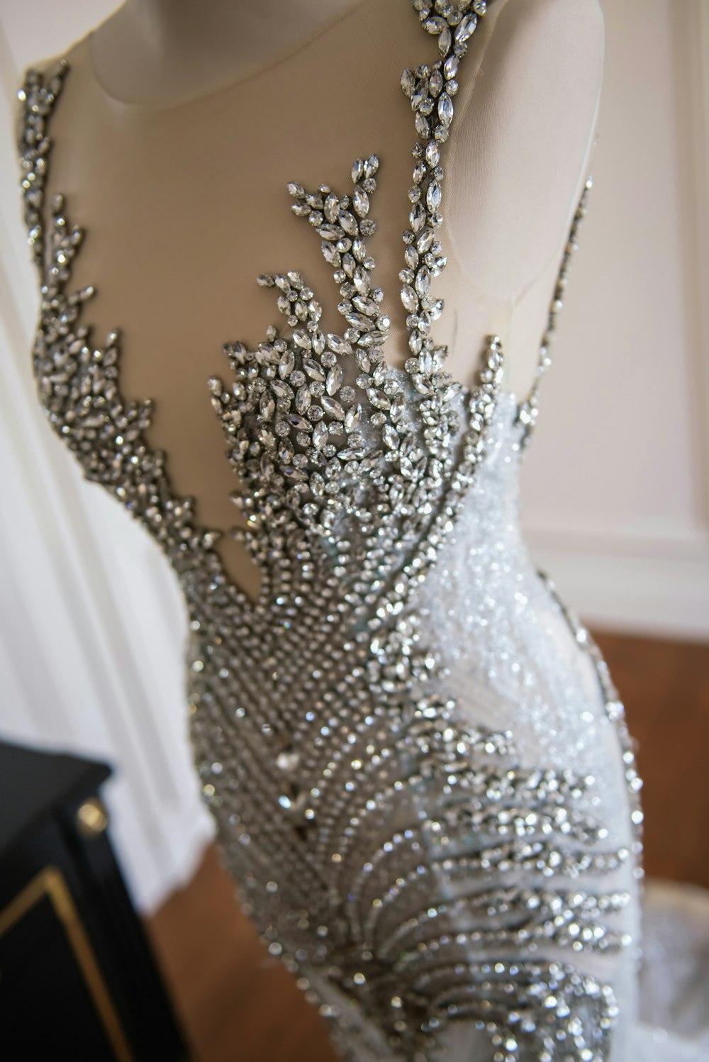 a dress made of silver beads on a mannequin