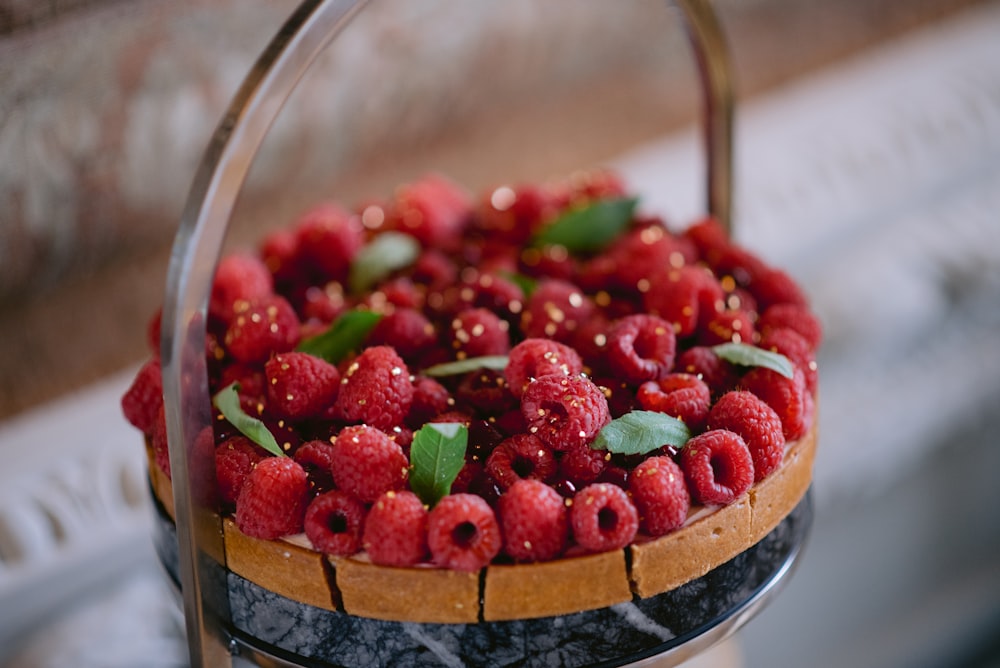 a close up of a cake with raspberries on it