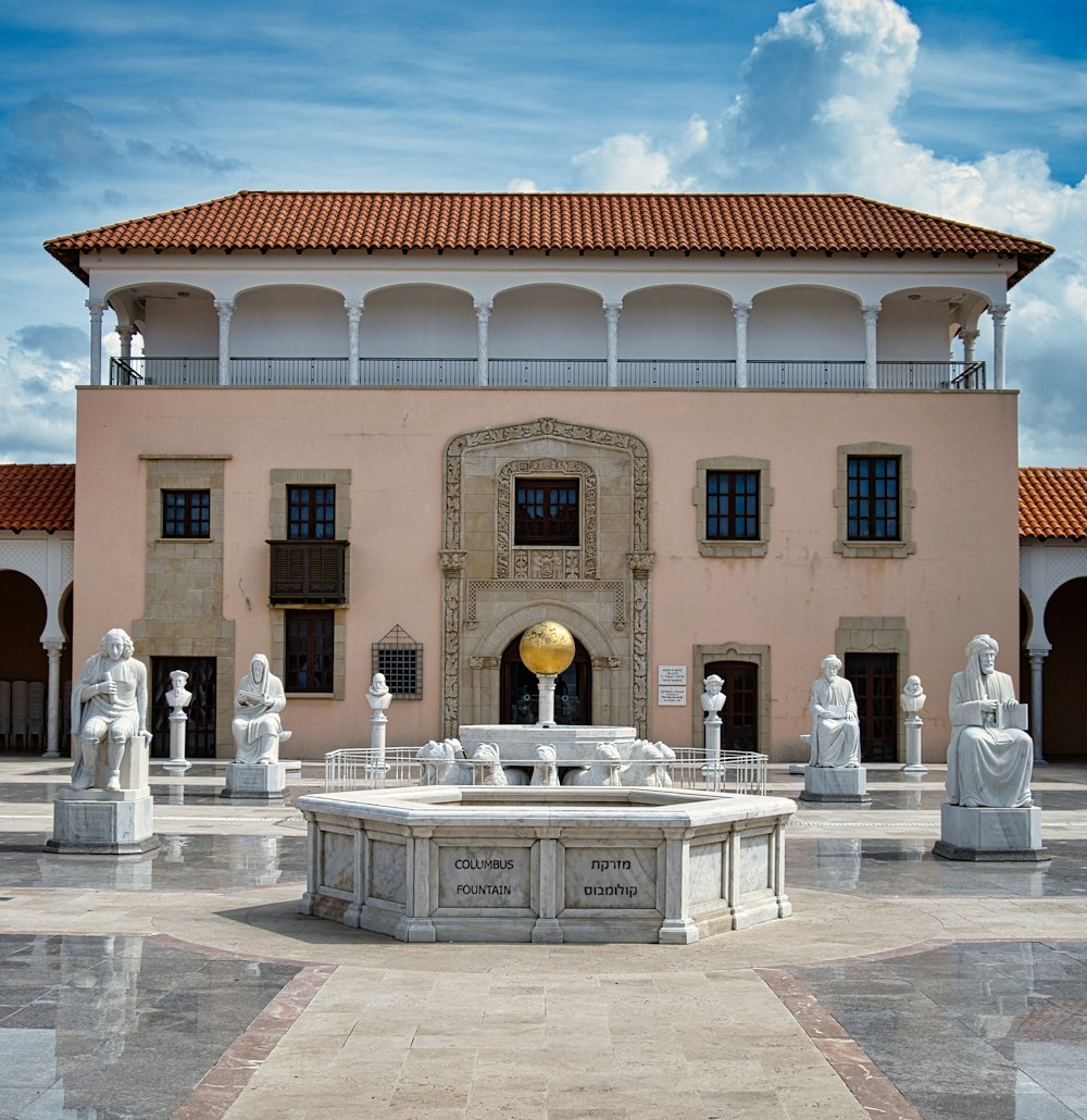 a large building with a fountain in front of it