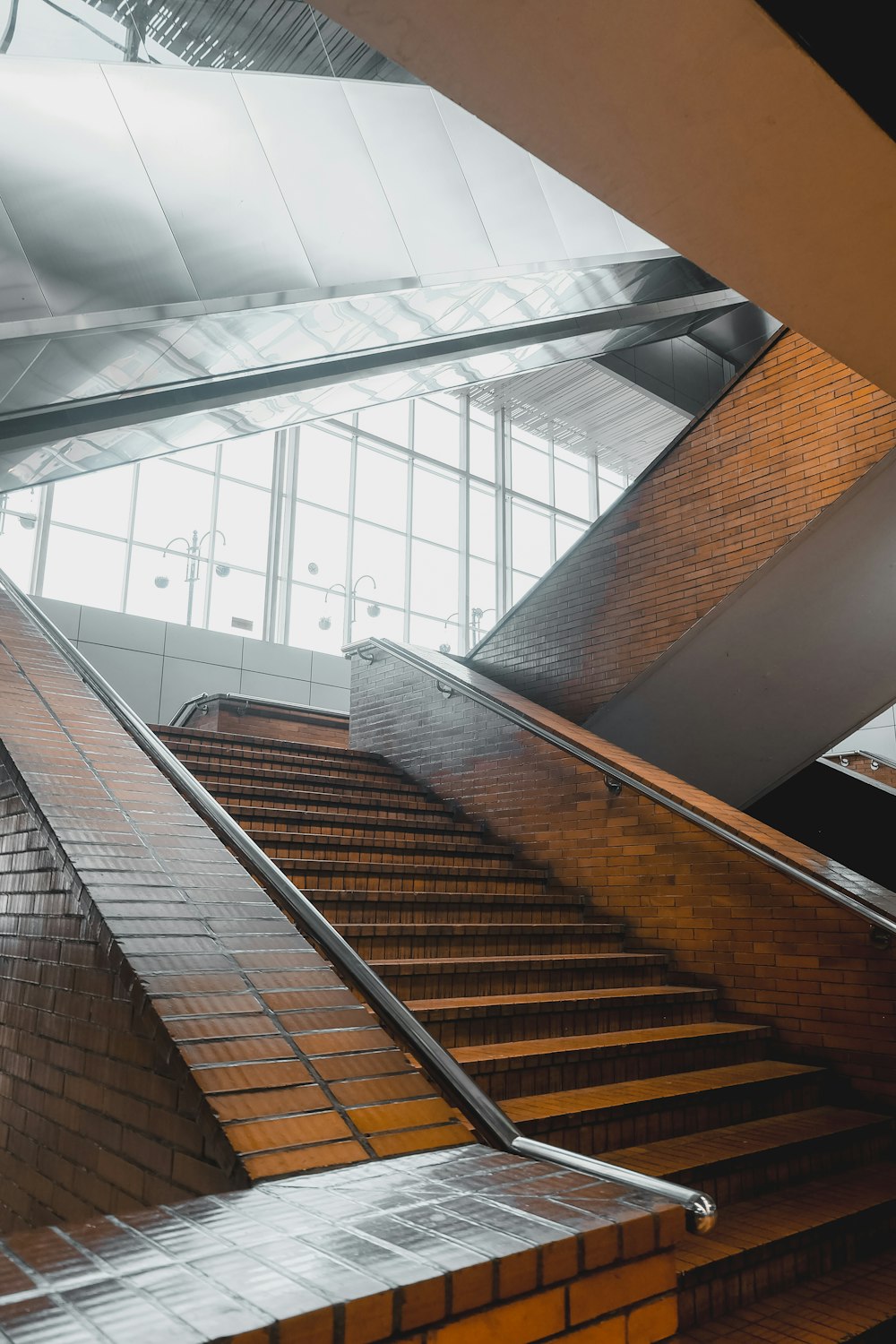 an escalator in a building with a brick wall