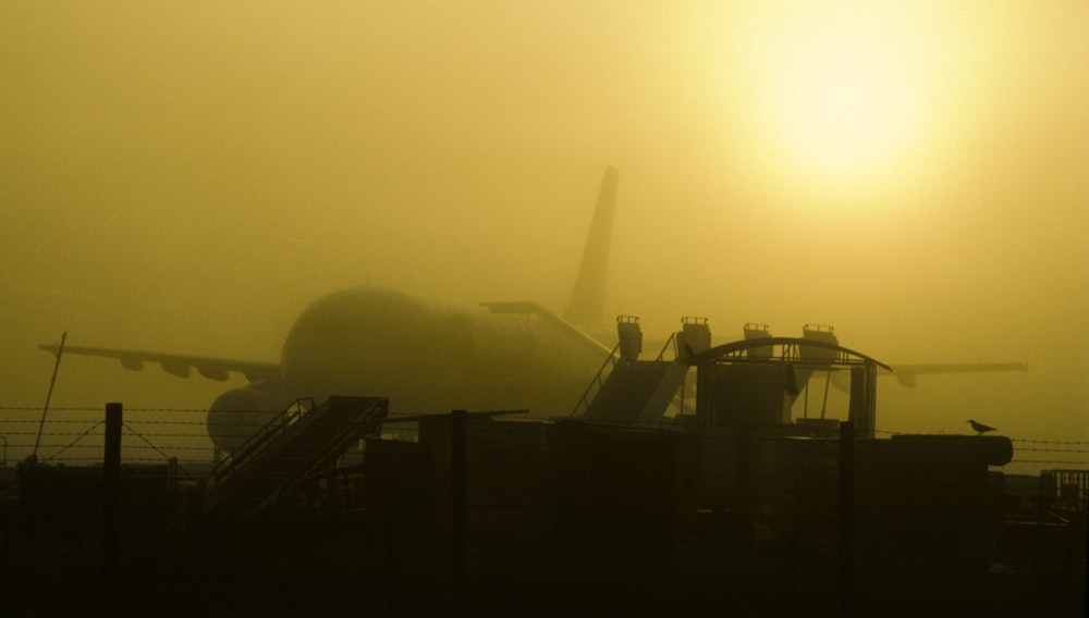 a plane is sitting on the runway in the fog