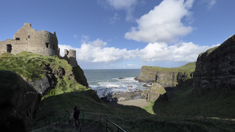 a person standing on a cliff overlooking a body of water