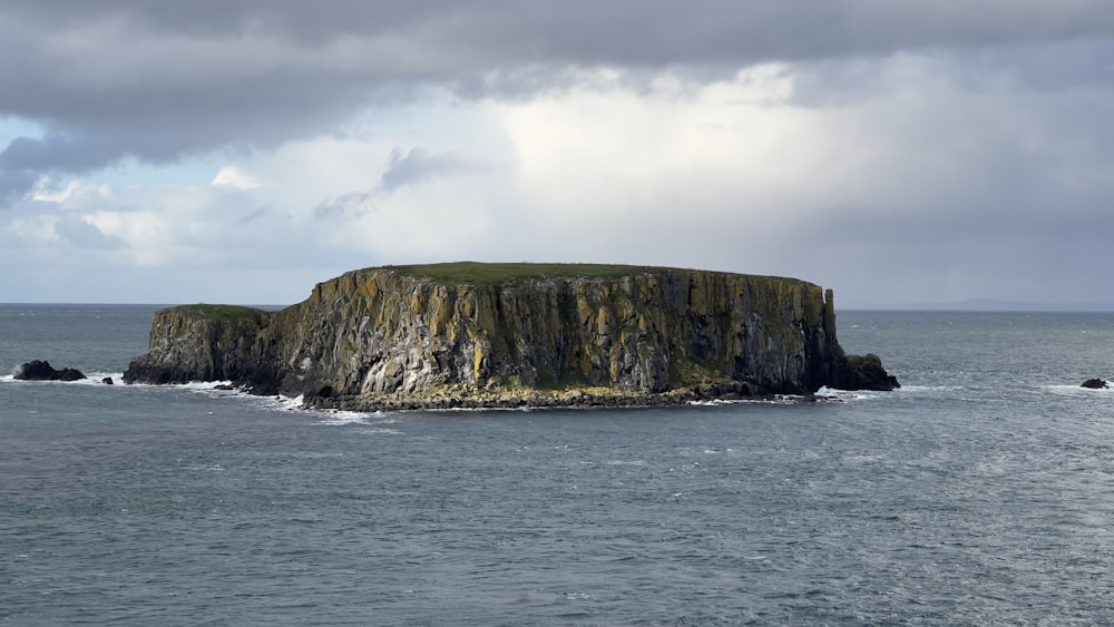 a rock outcropping in the middle of the ocean