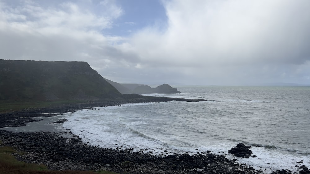 a body of water near a rocky shore