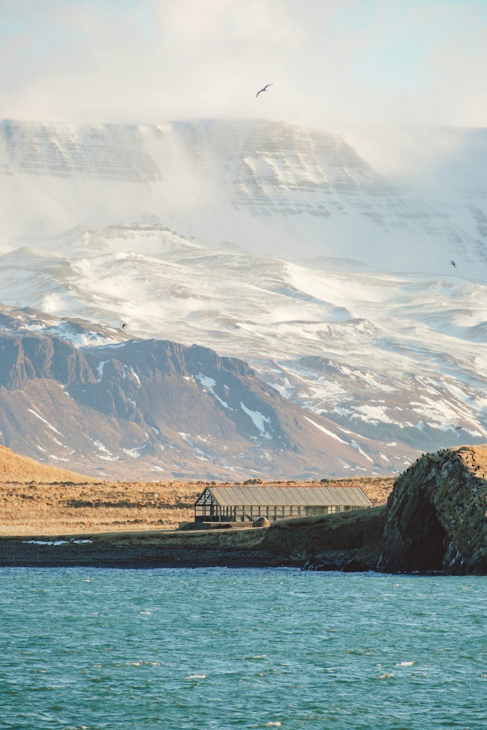 a large body of water with a mountain in the background