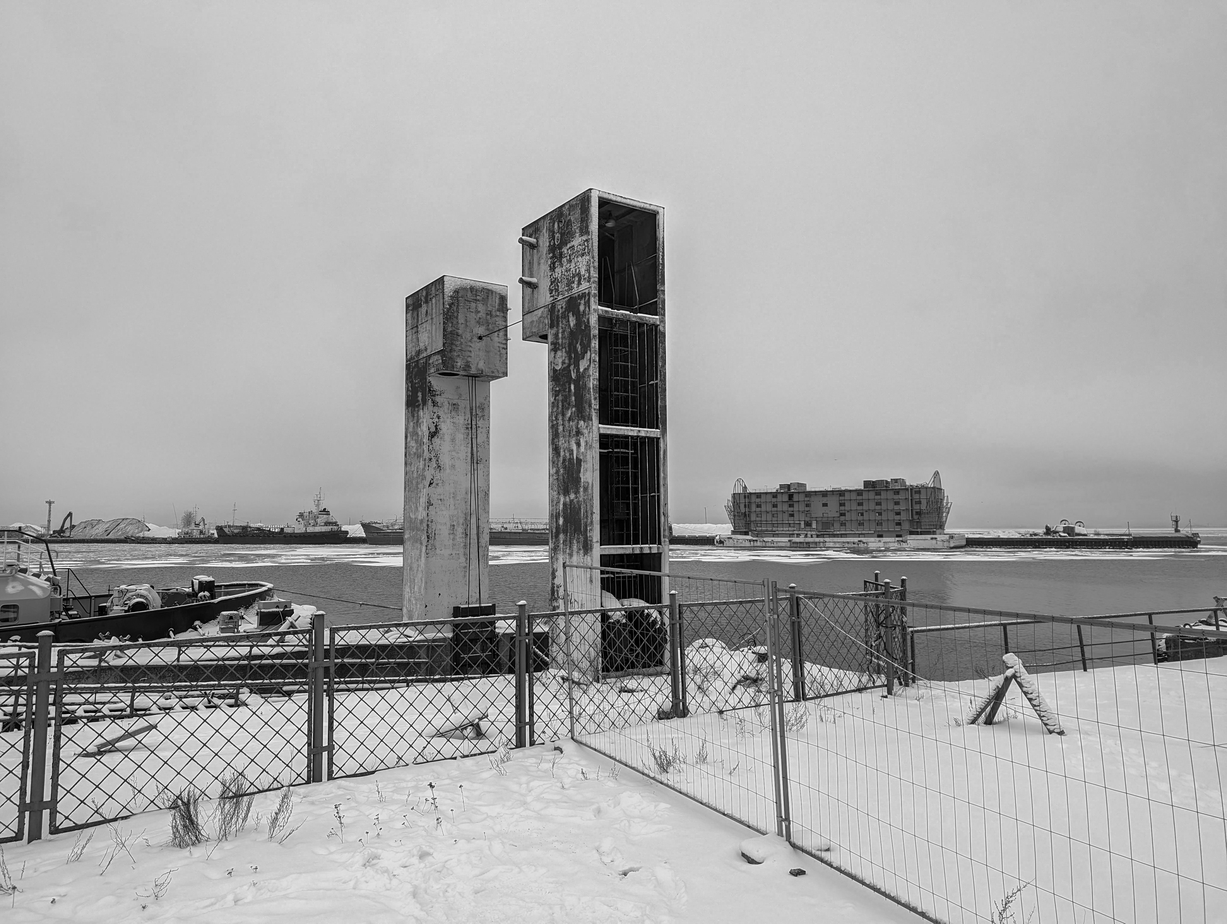 a black and white photo of a fenced in area
