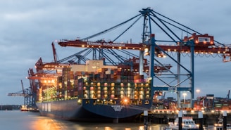 a large cargo ship in a harbor at night