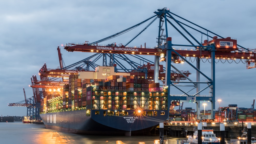 a large cargo ship in a harbor at night