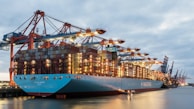 a large cargo ship docked at a dock