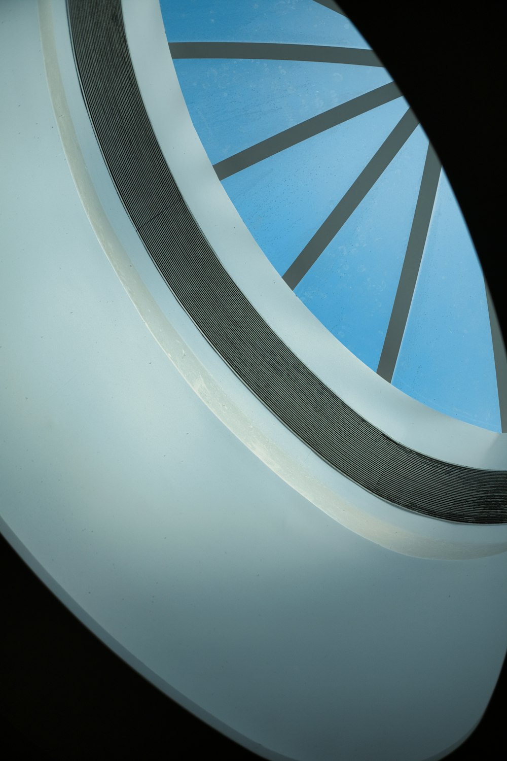 a circular window with a blue sky in the background