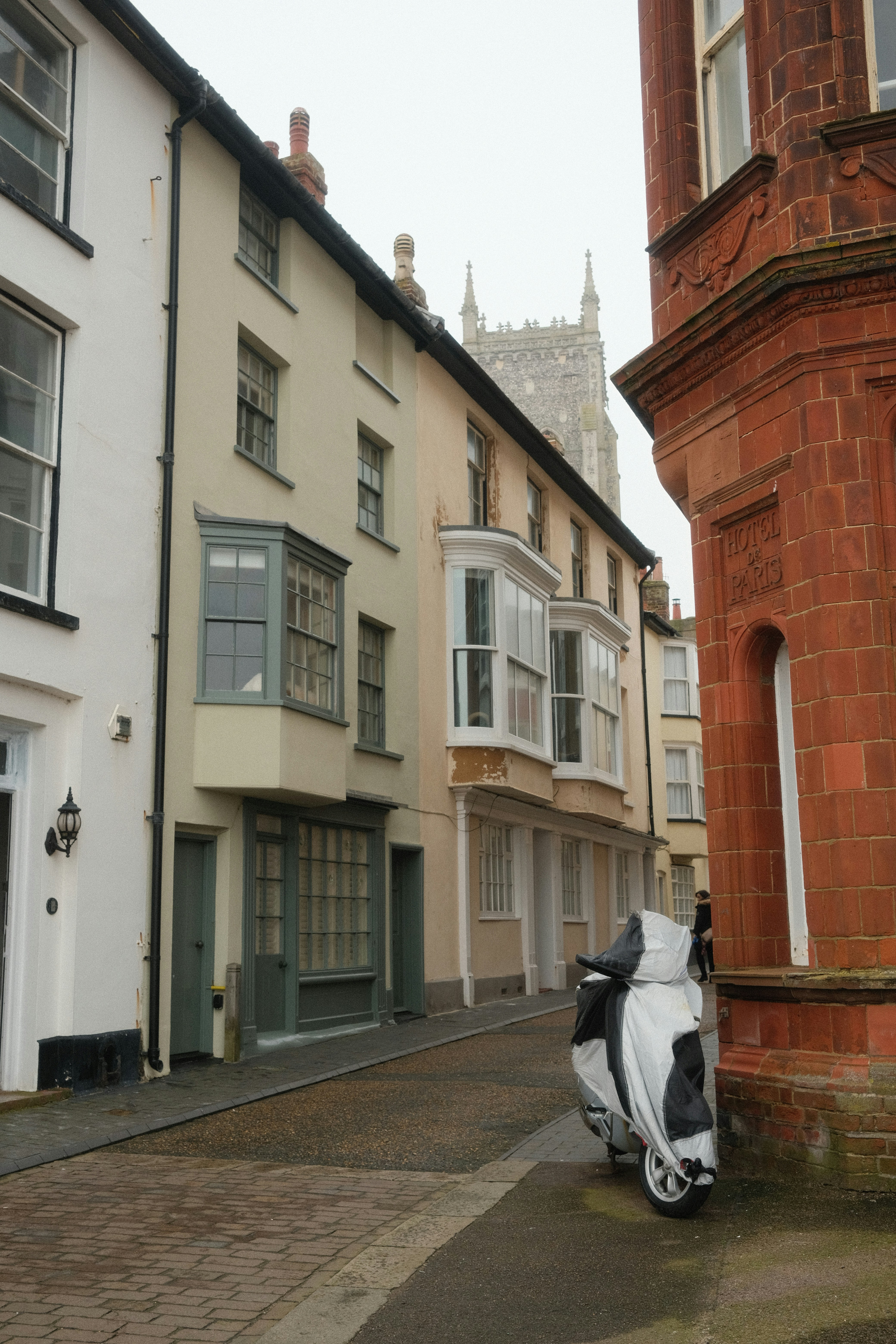 A scooter parked on the side of a street