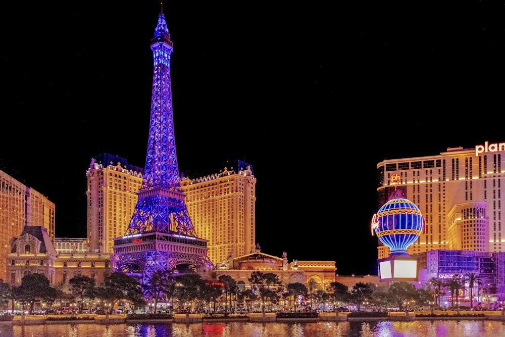 the eiffel tower is lit up at night