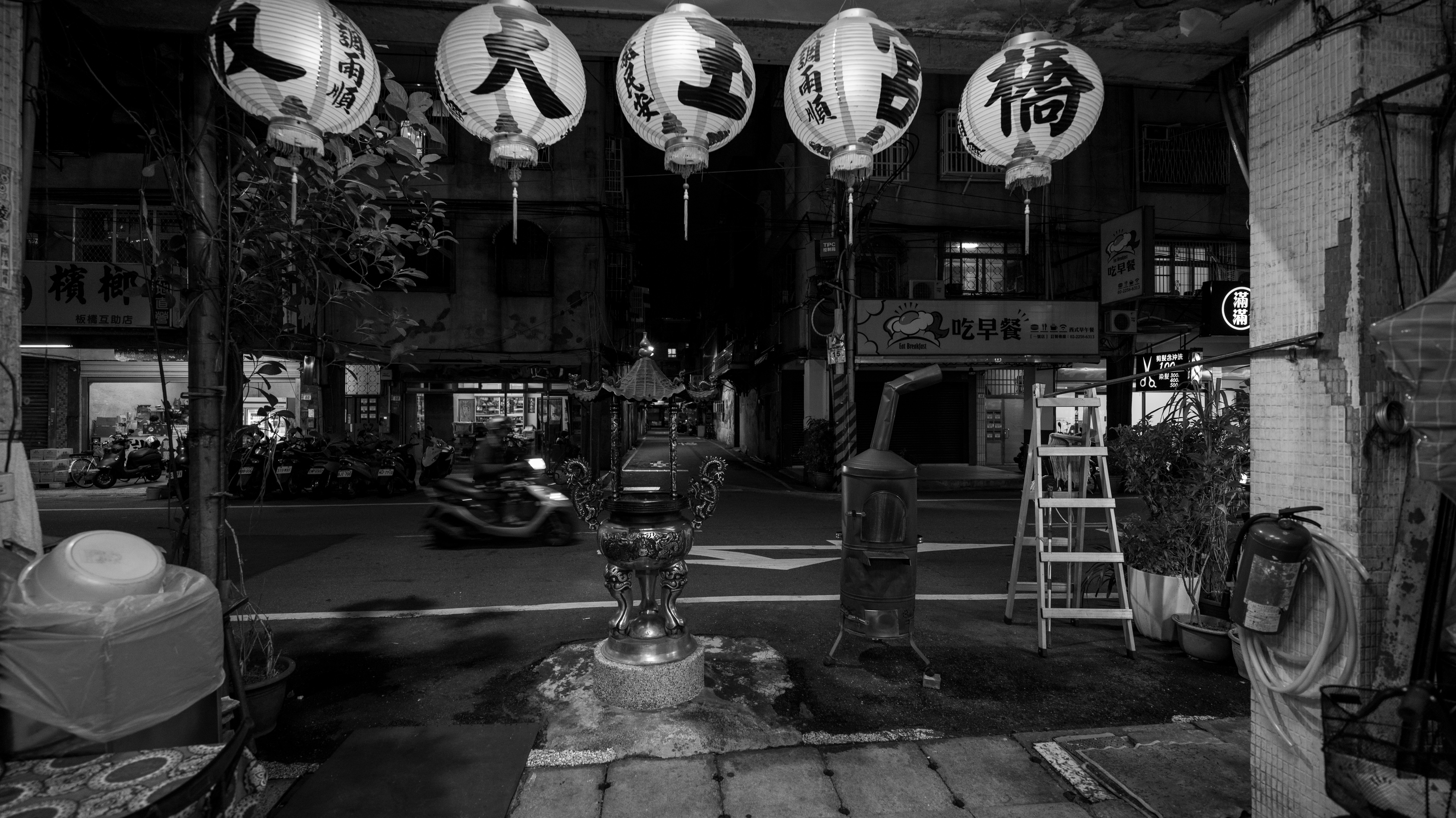 a black and white photo of chinese lanterns hanging from the ceiling