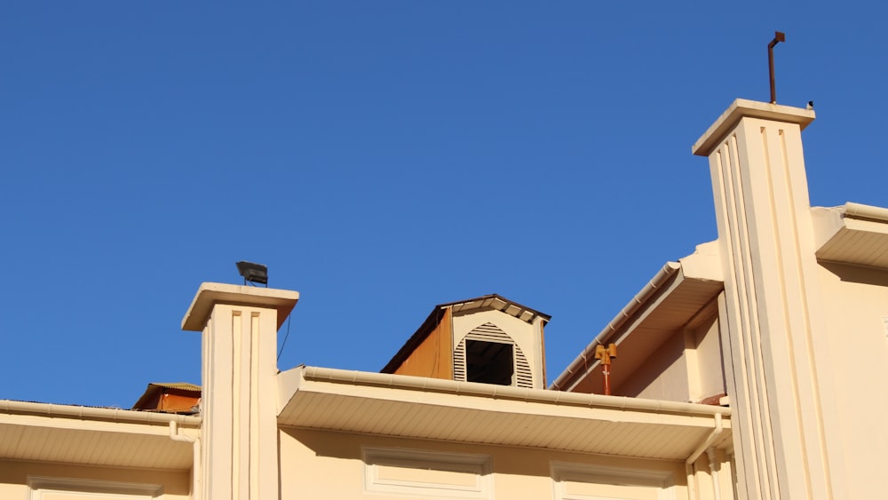 a bird is perched on the roof of a building