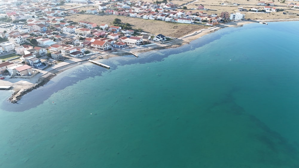 a bird's eye view of a small town next to the ocean