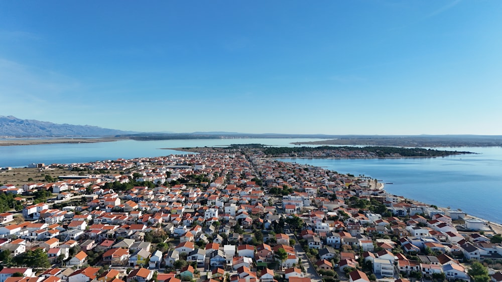 an aerial view of a city by the water