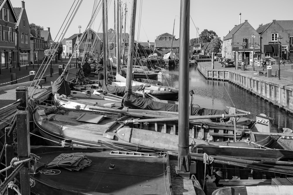 a black and white photo of boats docked in a harbor