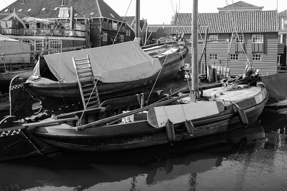 a black and white photo of boats docked in a harbor