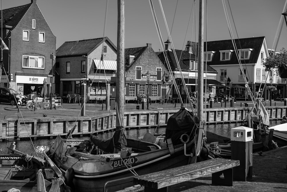 a black and white photo of a boat docked in a harbor