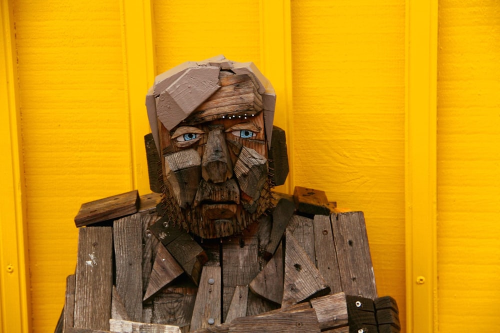 a wooden sculpture of a man with a beard