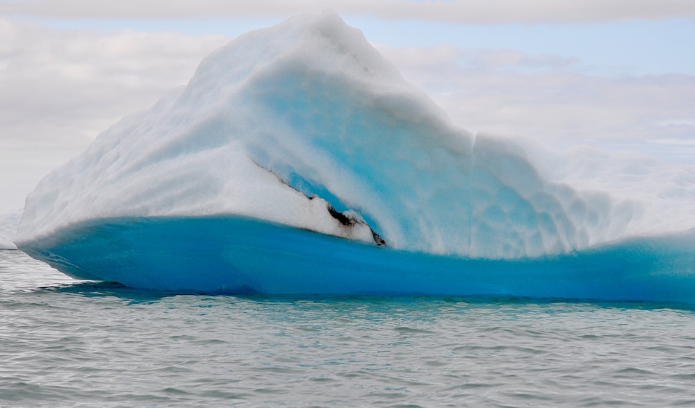 a large iceberg floating in the middle of the ocean