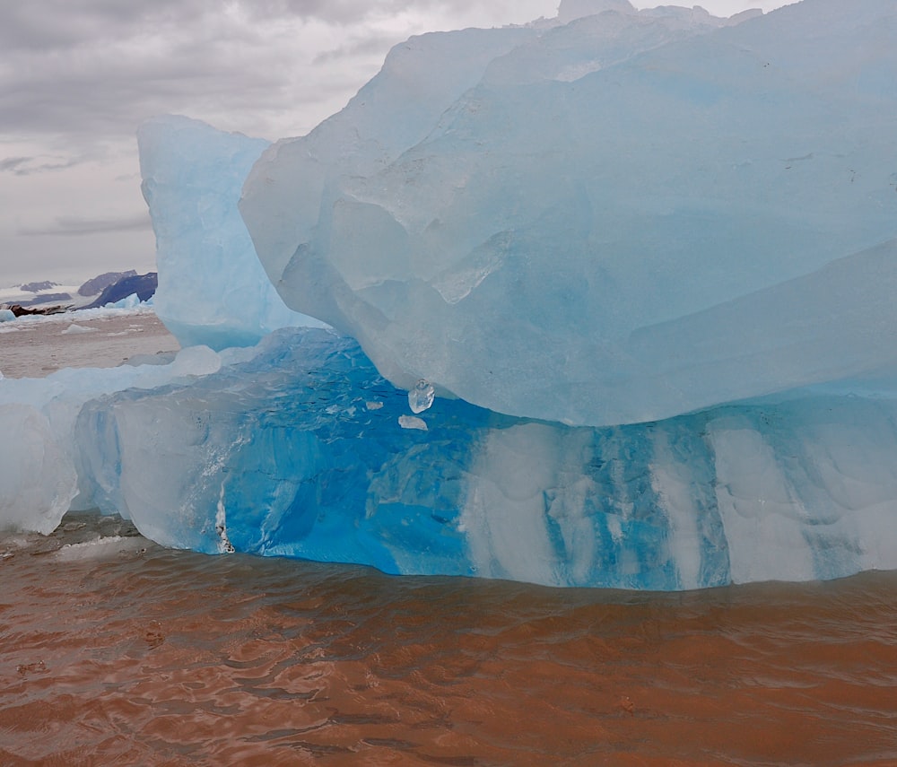 a large iceberg floating on top of a body of water