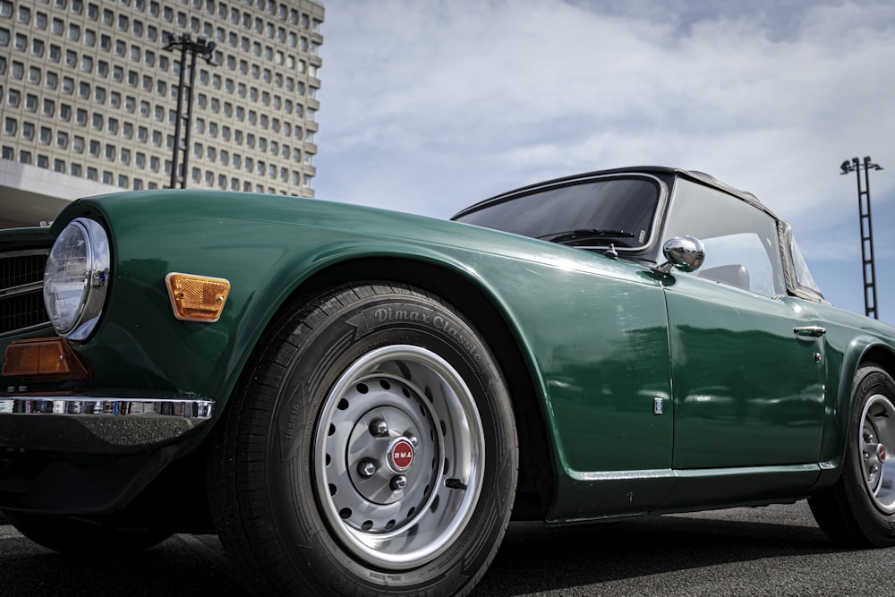 a green sports car parked in a parking lot