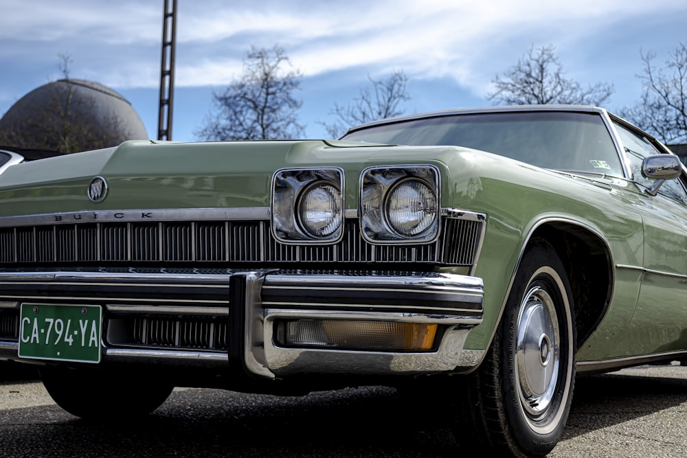 a green car parked in a parking lot