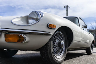 a white sports car parked in a parking lot