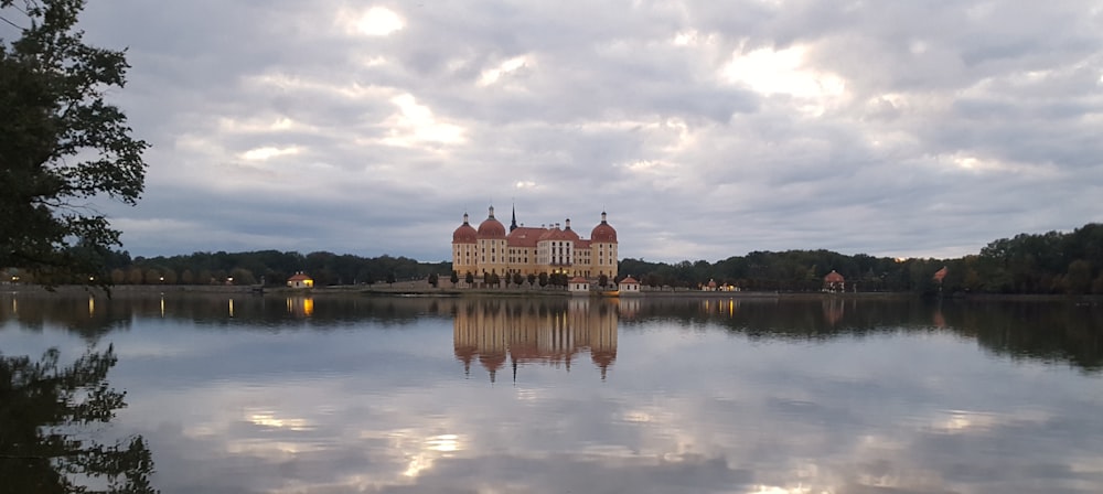 a large building sitting on top of a lake