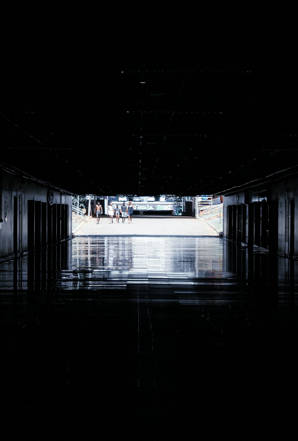 an empty parking garage with people walking in it