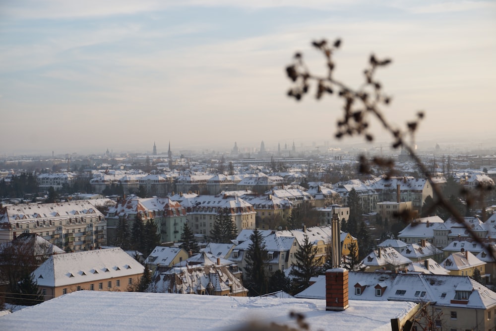 a view of a snowy city from a hill