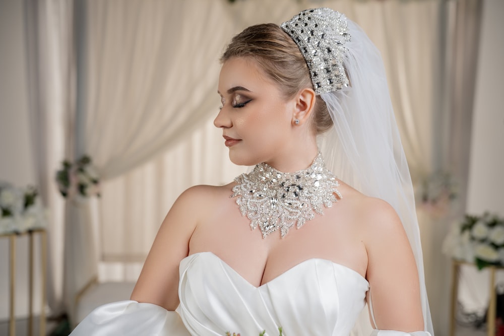 a woman in a wedding dress wearing a tiara