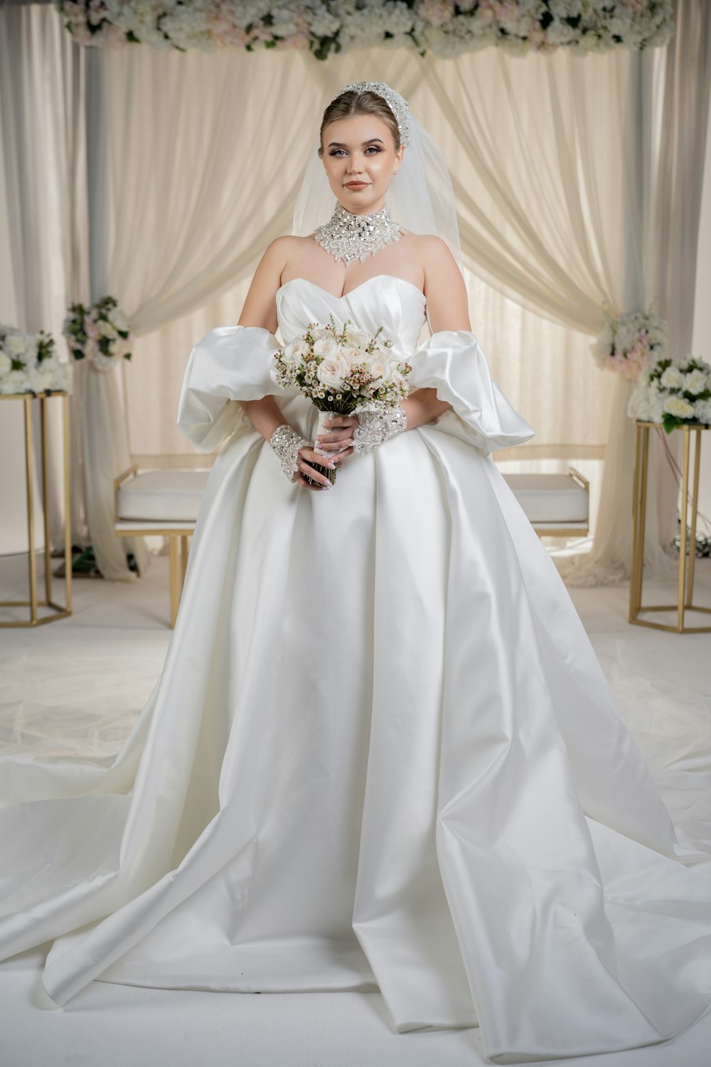 a woman in a wedding dress posing for a picture