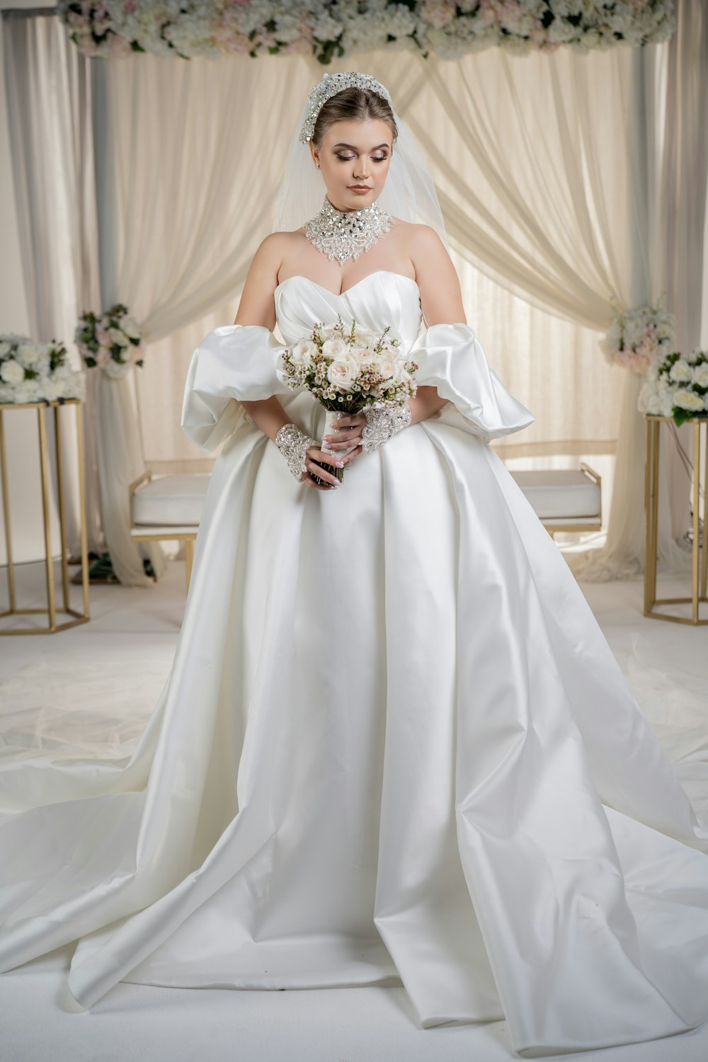 a woman in a white wedding dress holding a bouquet