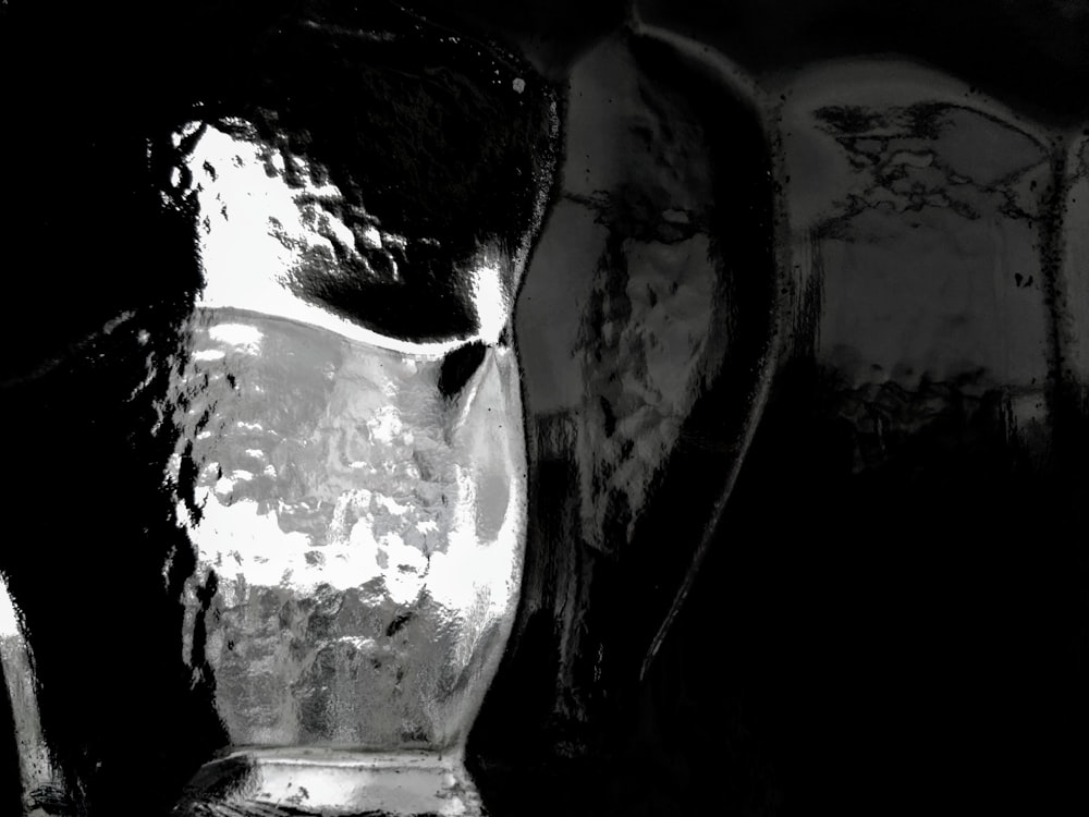 a black and white photo of a glass pitcher