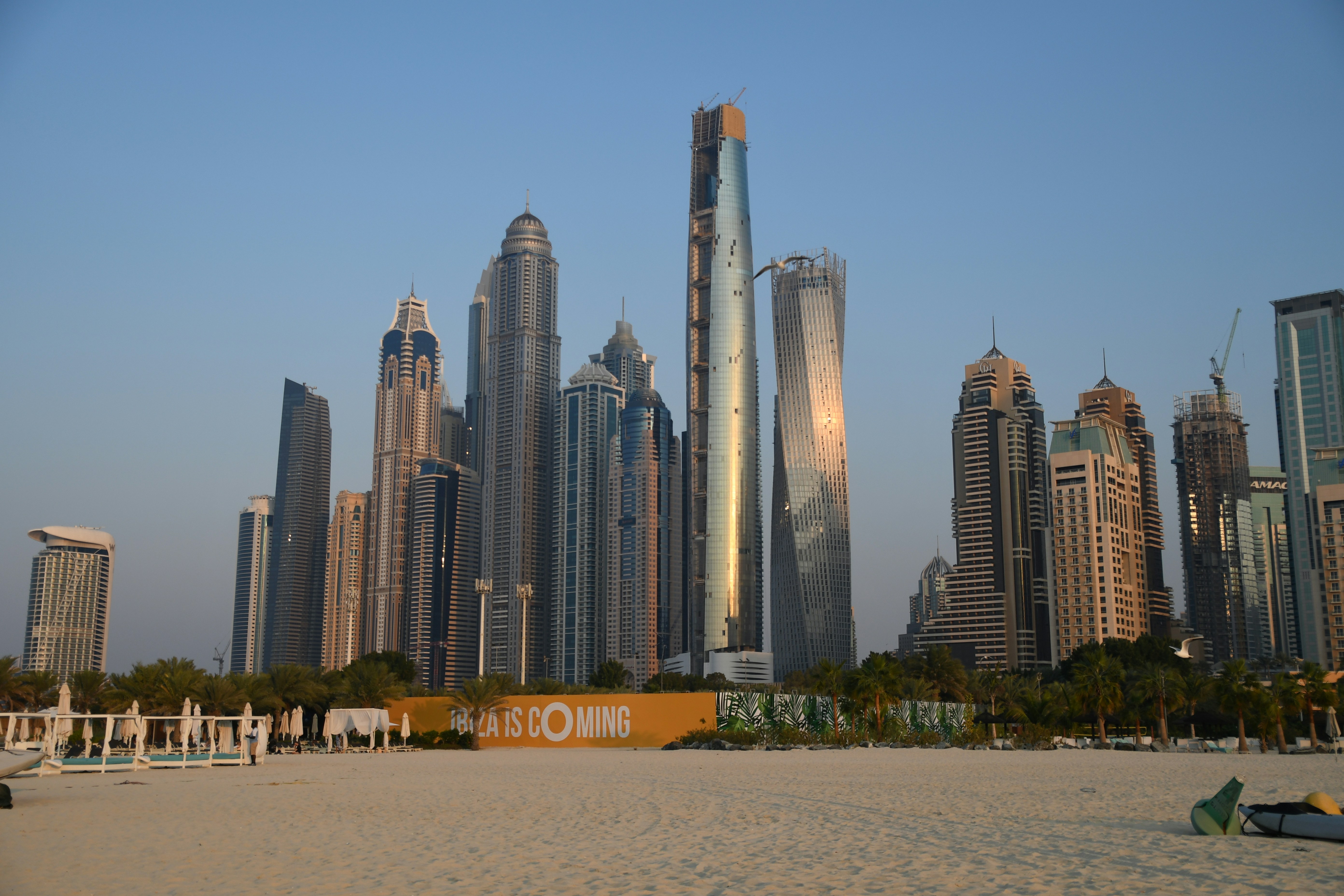 a beach with a lot of tall buildings in the background