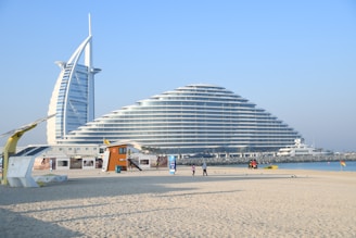 a large building sitting on top of a sandy beach