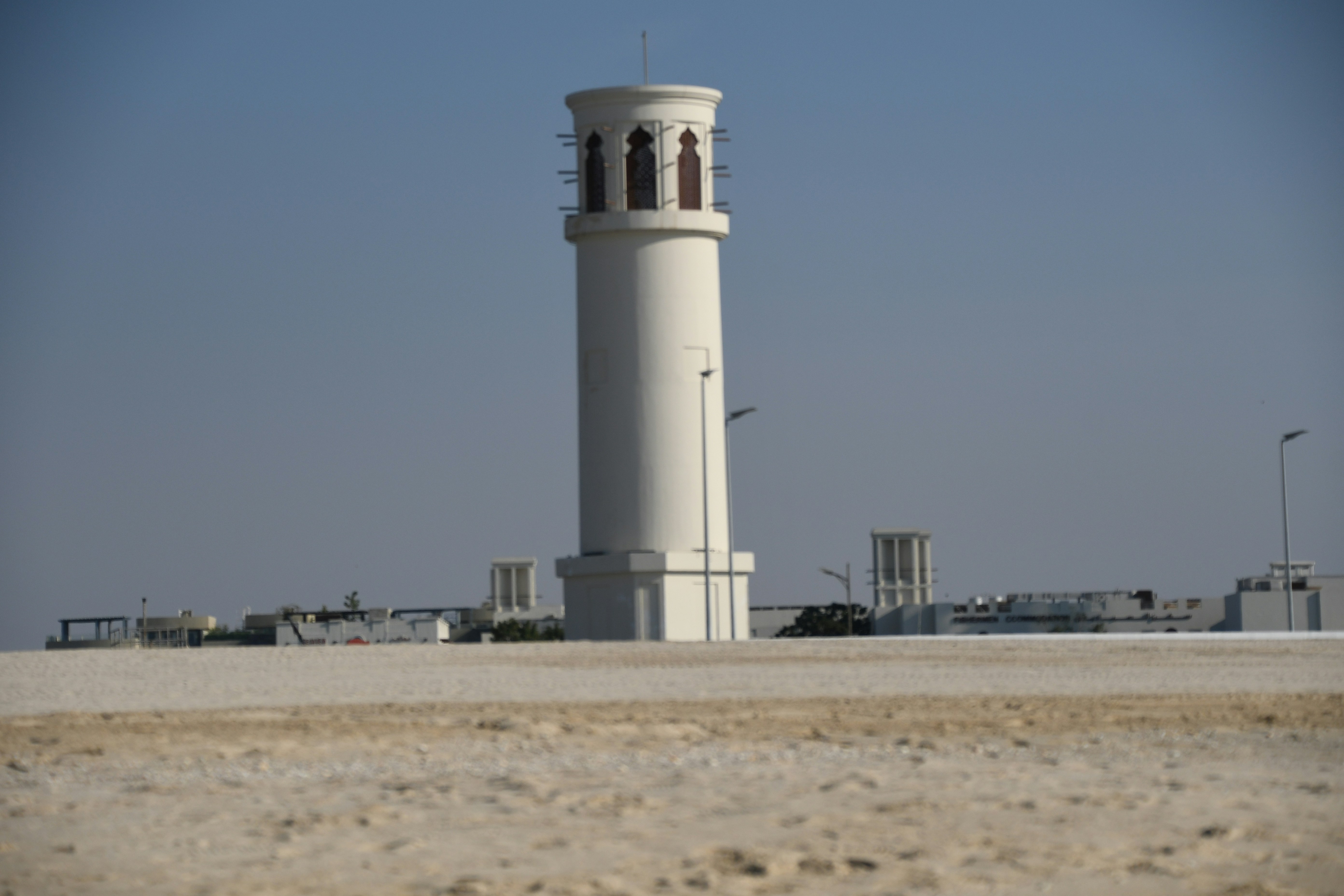 a tall white tower with a clock on top of it (Photo by SnapSaga on Unsplash)